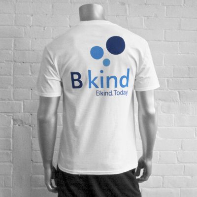 A man wearing a white t-shirt with the words " b kind brand today ".