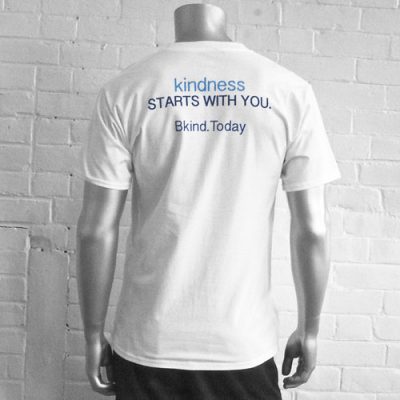 A man wearing a white shirt with the words " kindness starts with you ".