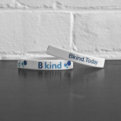 A bracelet that says bkind today and b kind today.