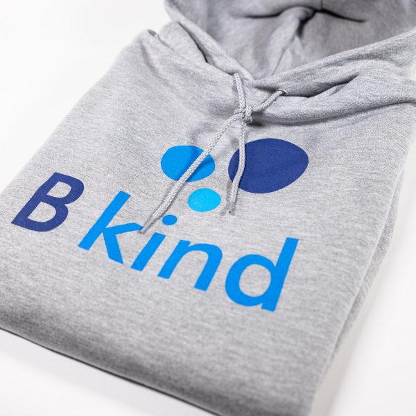 A close up of the hood of a hoodie with the word " b kind " printed on it.