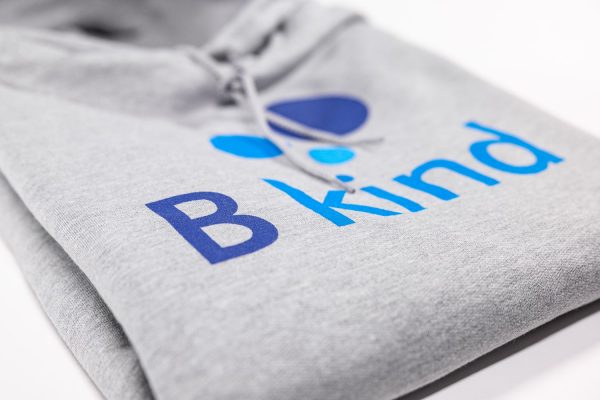 A close up of the b kind logo on a sweatshirt.