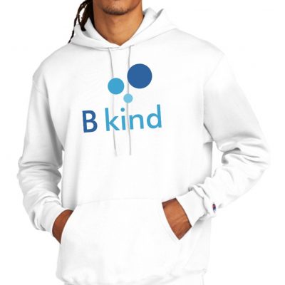 A man wearing a white hoodie with the word " b kind " on it.