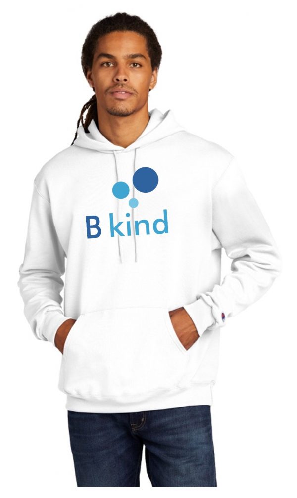 A man wearing a white hoodie with the word " b kind " on it.