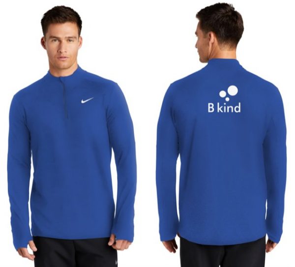 A man wearing a blue nike shirt with the word " b kind " on it.