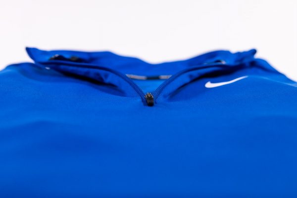 A close up of the zippers on a blue jacket.