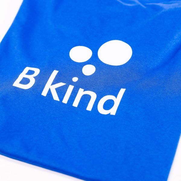 A blue bag with the word " b kind " written on it.