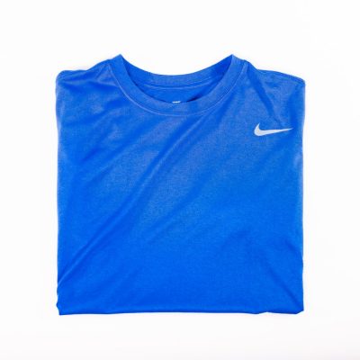 A blue shirt with white nike logo on it.