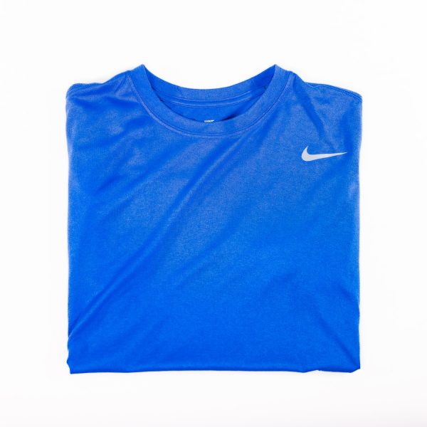 A blue shirt with white nike logo on it.