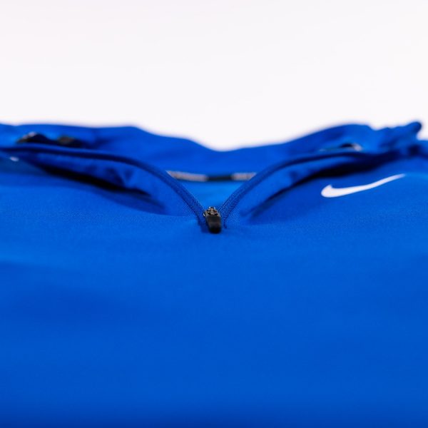 A close up of the zippers on a blue nike jacket.