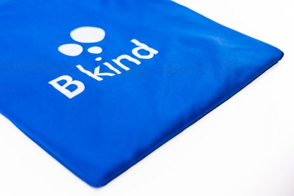 A blue bag with the word " b kind " on it.